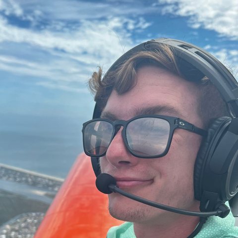 Brady Fredrickson in the cockpit, wearing a headset